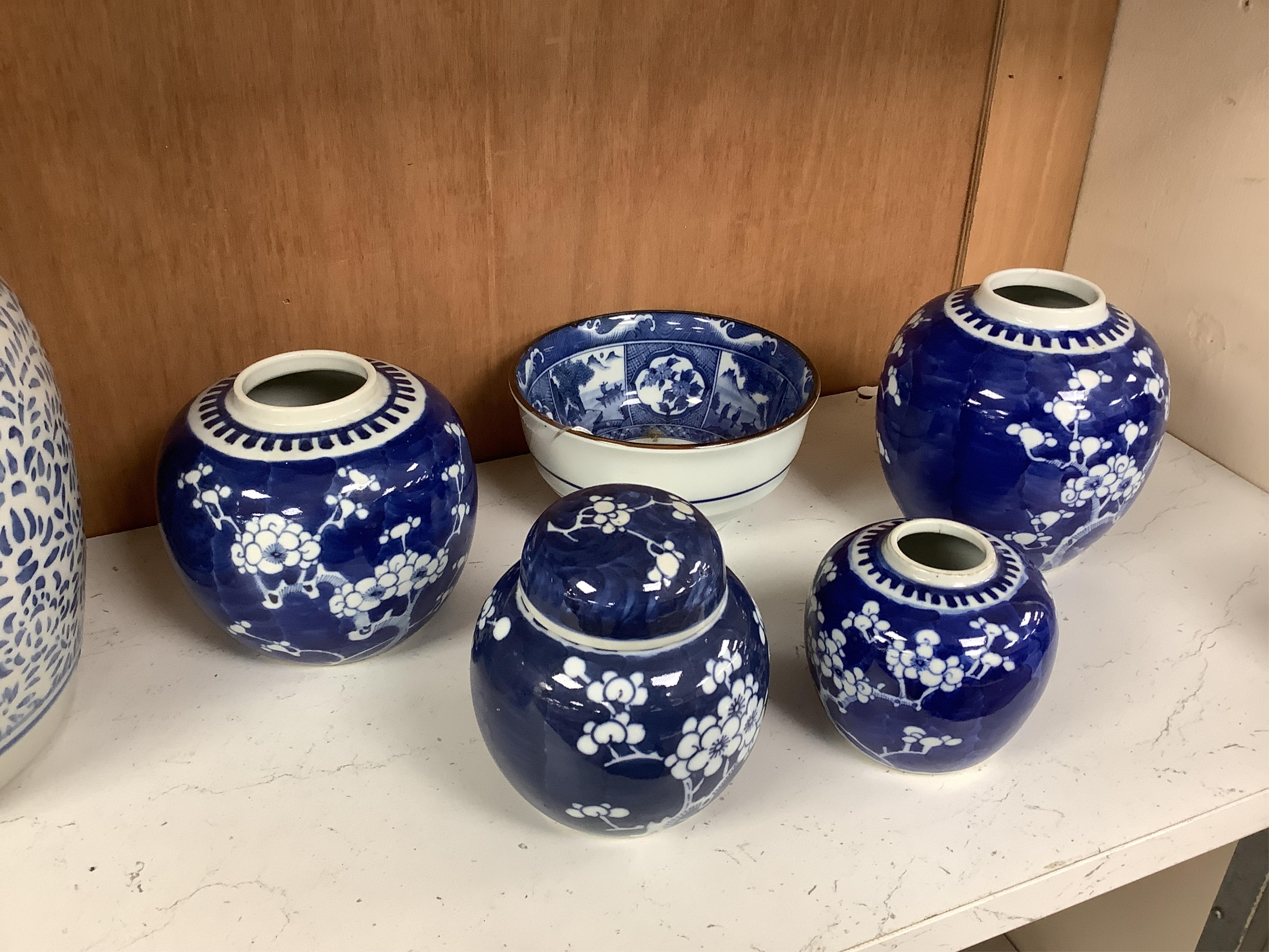 A group of Chinese blue and white porcelain, including a mid 19th century Canton enamel teabowl and a Japanese small dish, tallest 22cm. Condition - fair